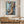 Abstract Driftwood canvas art in a black frame, hung above an oak sideboard in a bright Scandinavian dining room | MusaArtGallery™