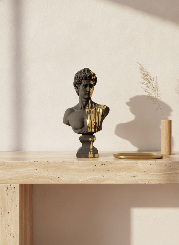 Black and gold David bust sculpture on a travertine console | MusaArtGallery