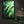 Emerald blaze green abstract canvas art in a black floating frame, hung above a green velvet armchair in a reading nook | MusaArtGallery™